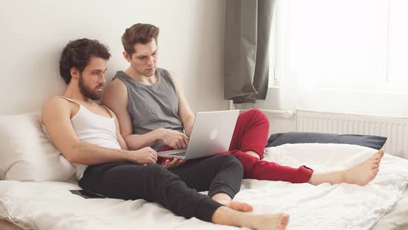European Gay Lgbtq Men Couple Using Computer Laptop at Home.