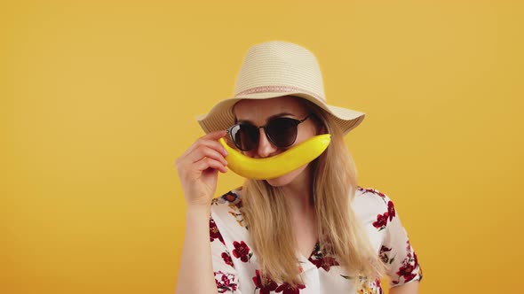 European Woman in Her 20s Wearing a Summer Hat Big Sunglasses and an Elegant Shirt with Flowers