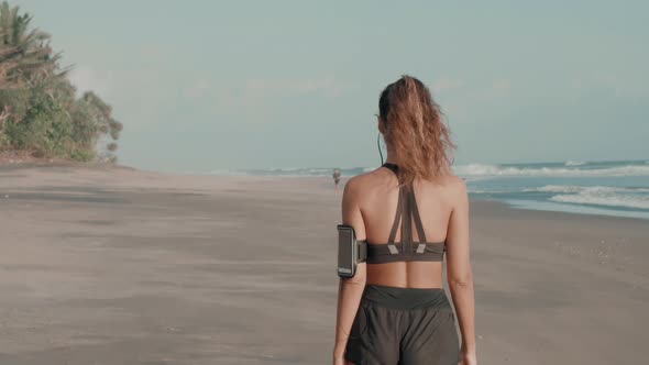 Sporty Girl Walking on Ocean Shore