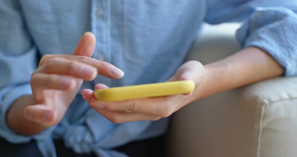 Close up of woman use of mobile phone at home