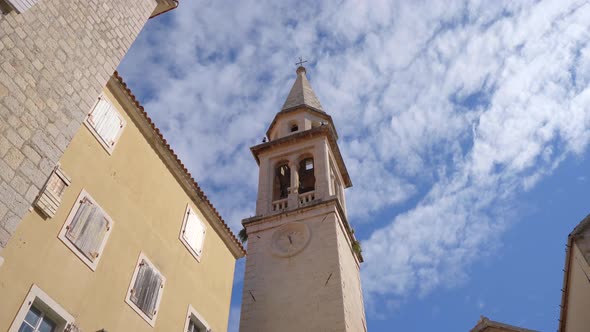 A Church with a Tall Bell Tower in the Old Town of Budva