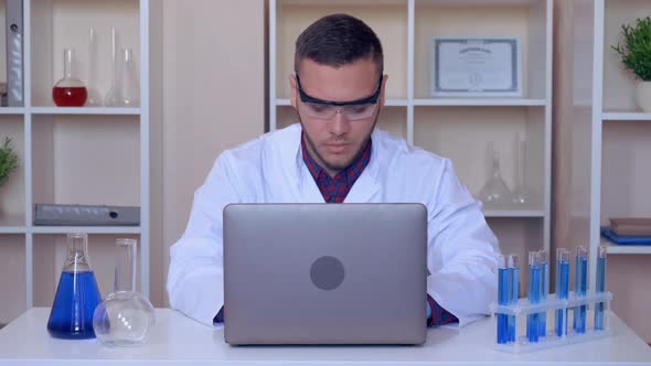 Worker Typing on Laptop