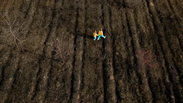 Ukrainian Girls in Clothes in the Colors of the Ukrainian Flag on the Ground