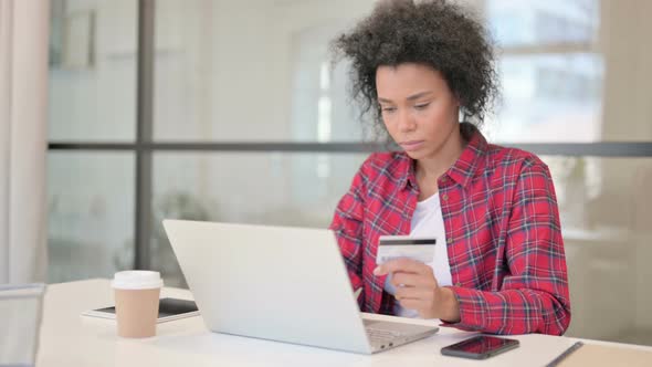 African Woman Making Successful Online Payment on Laptop