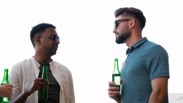 Happy Male Friends Drinking Beer at Rooftop Party