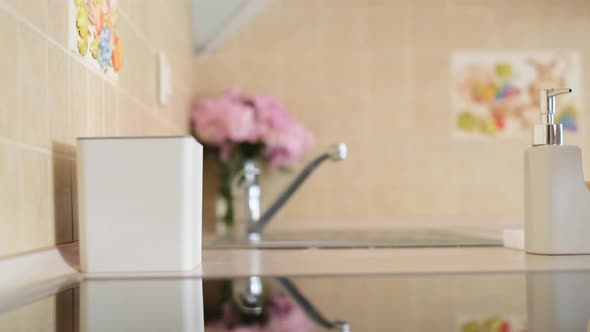 Young Woman Tidies Up in the Kitchen Coziness in the House