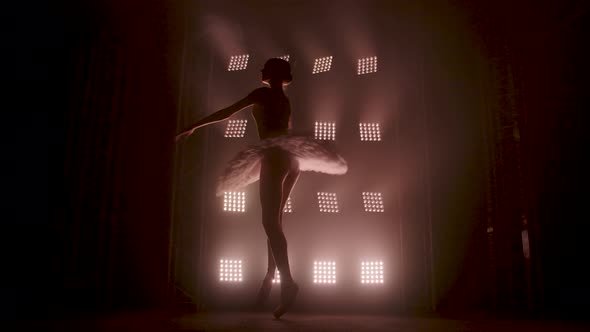 Graceful Silhouette Ballerina Dancing in Black Dress in the Studio in Spotlight on the Stage of the