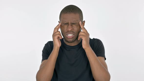 Young African Man with Headache on White Background