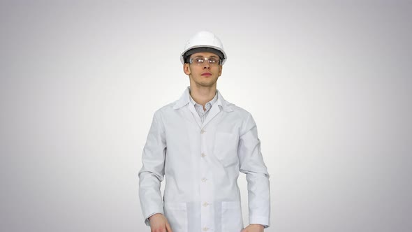 Scientist Engineer in White Robe, Safety Helmet and Glasses Making Funny Moves with His Eyes in the