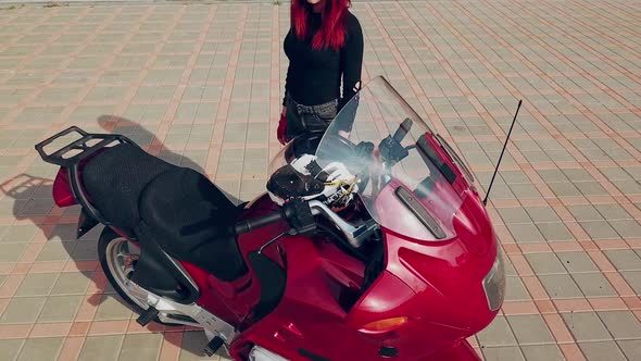 Woman sitting on motorcycle. Top view of woman sitting on modern custom motorcycle