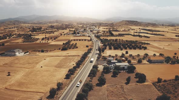 Aerial View Car Road Through Sunny Countryside in Mountains