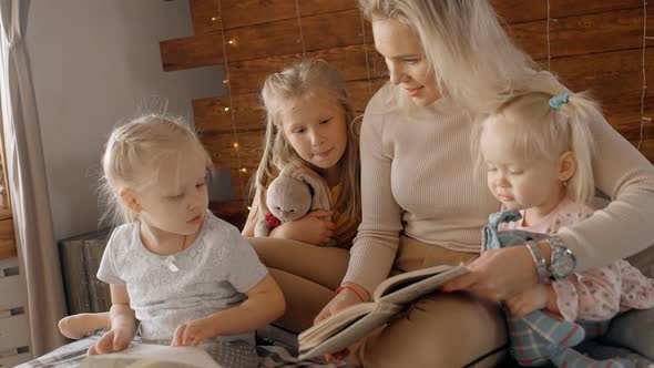 Woman Reading Book with Children at Home