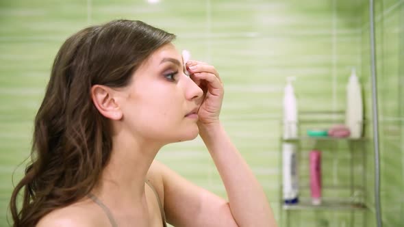 Girl Removes Makeup Using Cotton Pad Green Bathroom