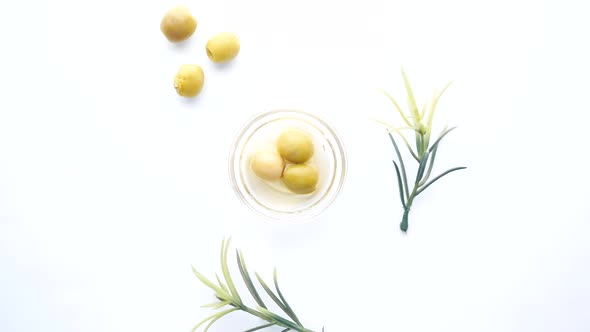 Green Olive in a Container on White Background