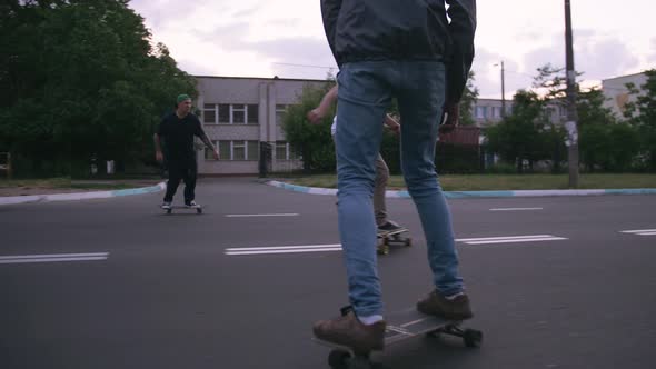 Group of Young People Skateboarding on the Road in the Early Morning Cinematic Shot Slow Motion