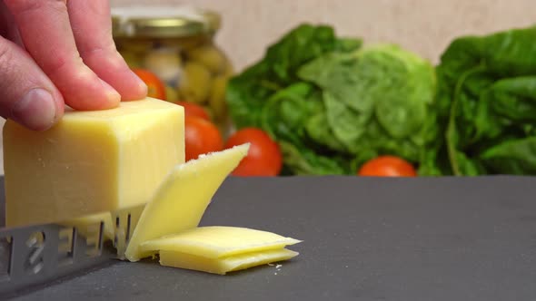 Slicing Cheese Parmesan Chopping Parmesan Cheese with a Knife on a Cutting Board Preparing Healthy