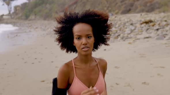 Slow motion shot of an Somali woman jogging on the beach