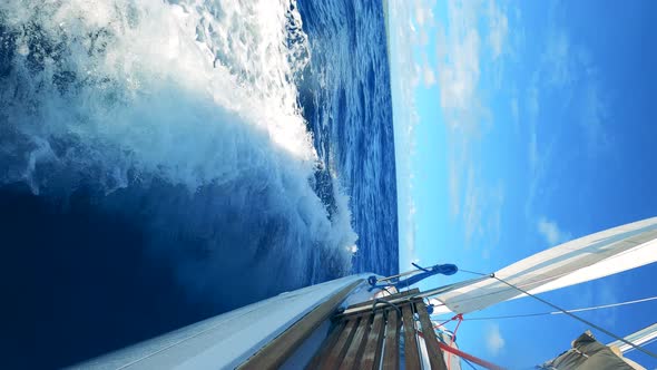 Perpendicular View of a Sailing Boat in the Ocean