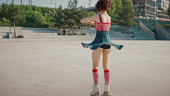 Young Beautiful Lady in Classic Quads Rinking Alone in Urban Park Dancing Gracefully Tracking Shot