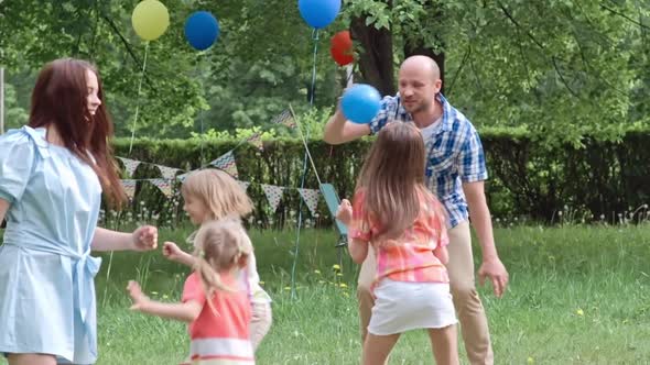 Kids Playing with Daddy Outdoors alt
