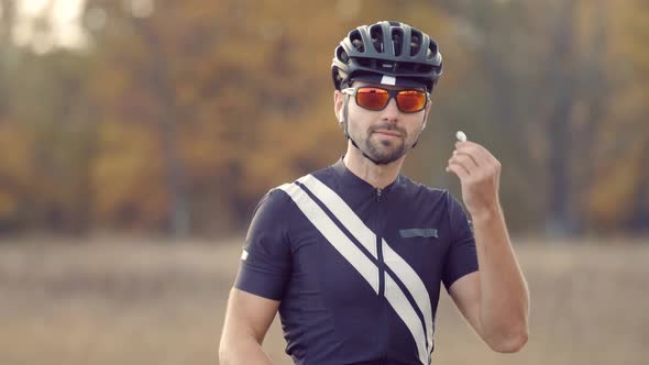 Cyclist Listening Music In Wireless Earphones. Athlete Putting In Ear Wireless Earphones. Headphone.