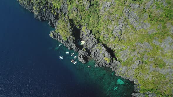 Passenger Boat at Cliff Ocean Shore at Tranquil Seascape Aerial View