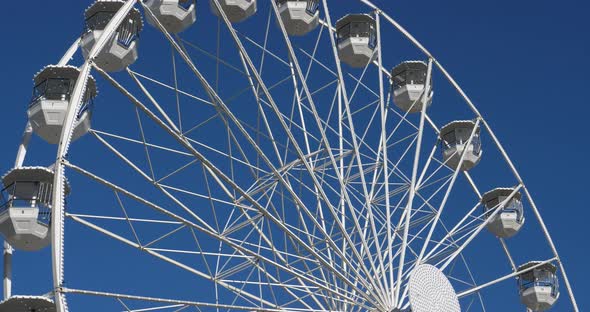 Ferris wheel in action againts a blue sky.