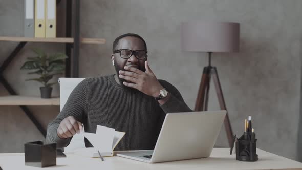 Sleepy Black Man in Office Male in Casual Work with Laptop and Yawning