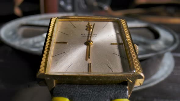 Gold Wrist Watch with Rotating Hands in Time Lapse Video