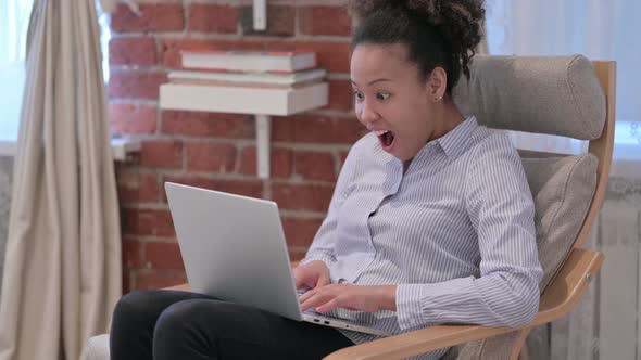 African American Woman with Laptop Celebrating Success