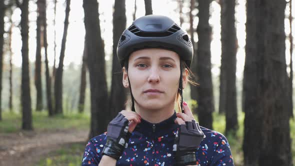 Woman wears black helmet before bicycle ride