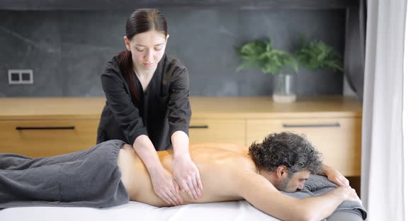 Female Masseur Doing Massage to Male Client