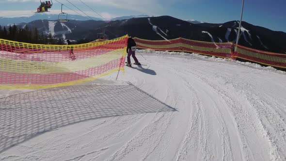 First-person View Skiers and Snowboarders Slide Down on Ski Slope at Ski Resort