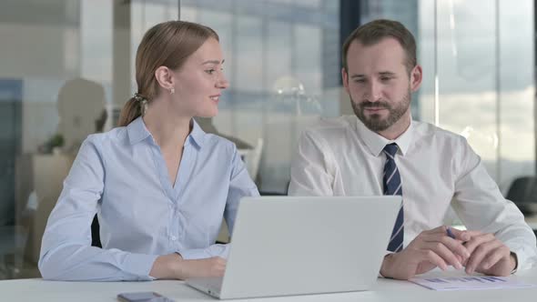 Business People Sharing Idea on Laptop in Office