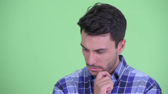 Face of Stressed Young Hispanic Man Thinking and Looking Down