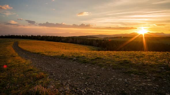 Sunset time lapse viewing dirt road through the Idaho landscape