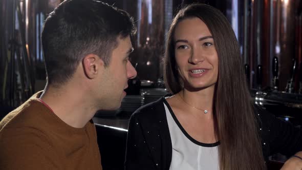 Young Couple Talking Joyfully at the Restaurant Over Cup of Coffee