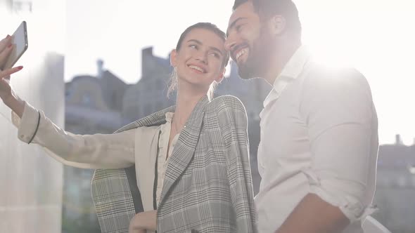 Happy Couple Making Photo On Phone Outdoors