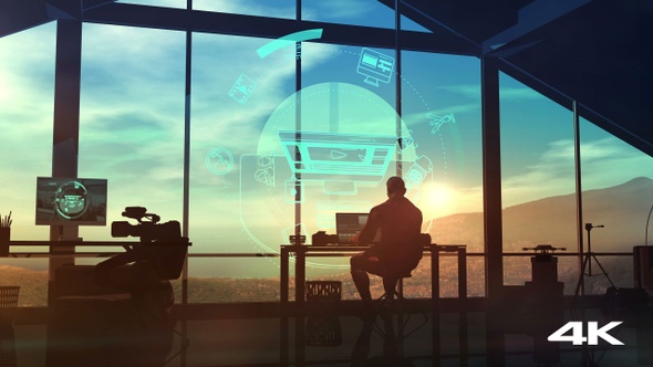 The silhouette of a videographer at a workplace in his office 4K