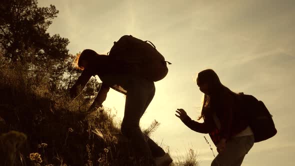 Hiker Girl. Girls Travelers Climb Mountain Holds Out Their Hand Helping To Climb. Family of Tourists