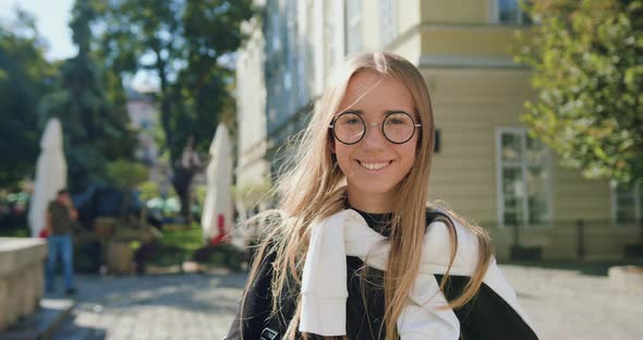 Modern Young Blondie in Glasses Looking at Camera with Sincerely Smile