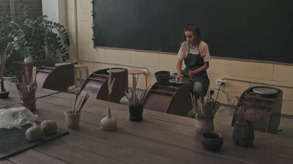 Woman Shaping Clay on Pottery Wheel