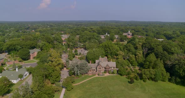 Flying Towards a Historic Mansion House Amongst Trees in Glen Head Long Island