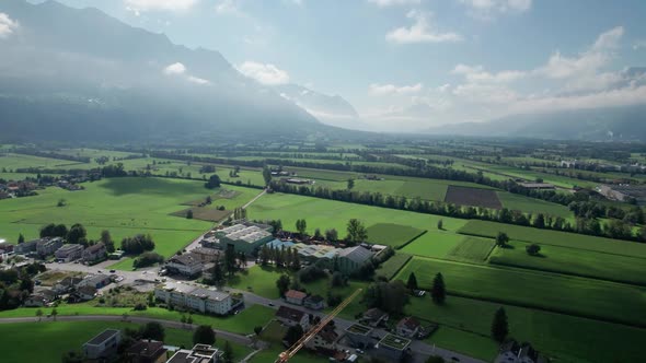 Aerial View of Liechtenstein with Houses on Green Fields in Alps Mountain Valley