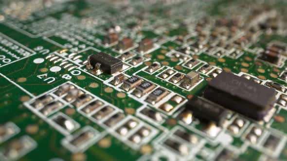 Extreme Closeup of Green Printed Circuit Board Electronics Shot with Dolly