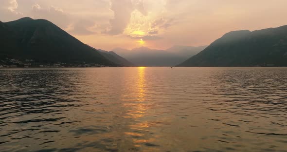 flying towards a sunset over kotor bay