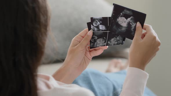 Back View Pregnant Unrecognizable Fertile Woman Girl Future Mother Wife Sitting on Sofa at Home