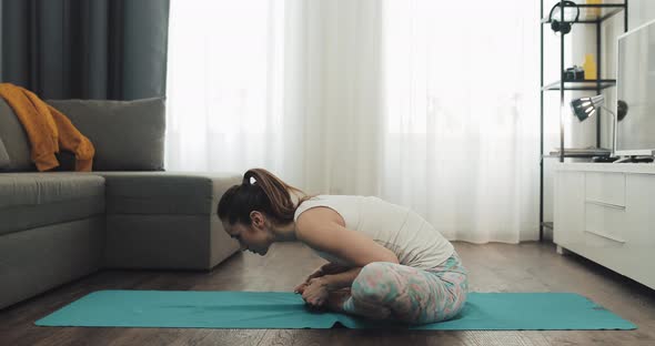 Young Woman Doing Yoga at Home. Healthy and Sport Lifestyle.