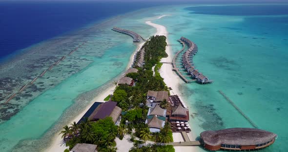 Wide birds eye travel shot of a summer white paradise sand beach and aqua turquoise water background