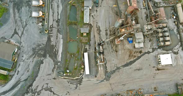 Aerial View of Open Cast Mining Panorama Quarry with Lots of Machinery at Work Equipment at a Plant